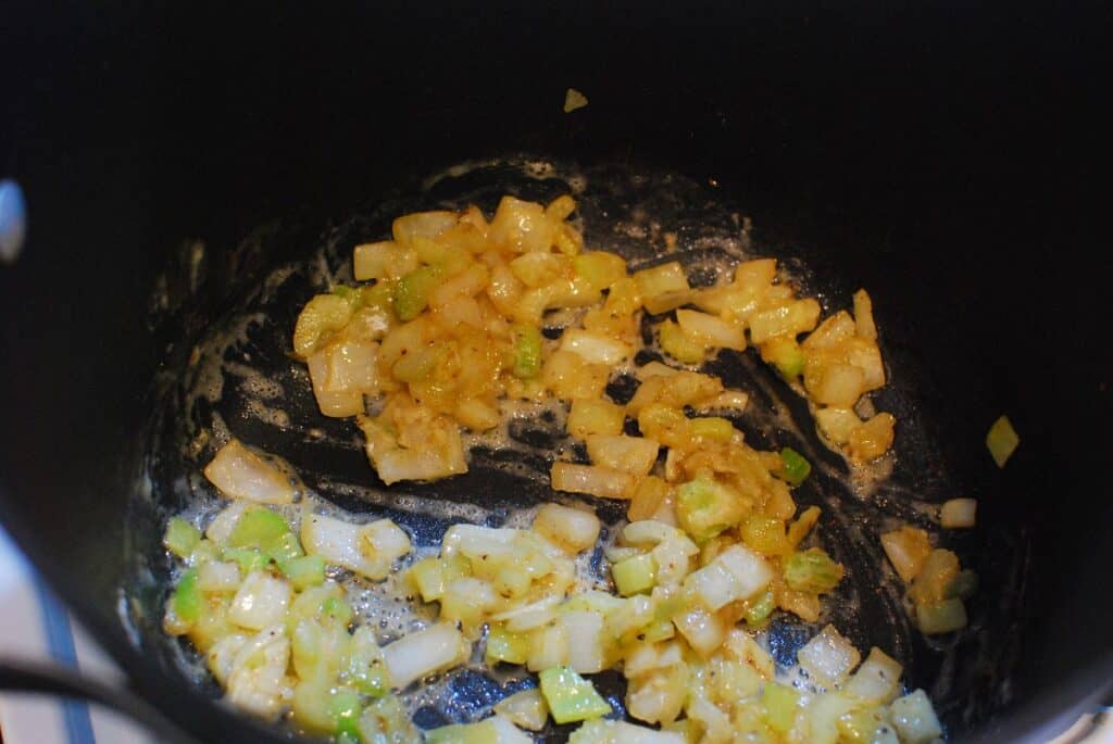 Flour stirred into the pot with the vegetables.