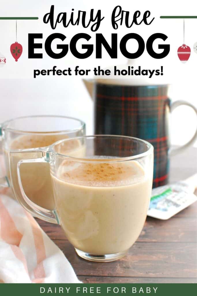 A clear mug with dairy free eggnog next to a napkin and a pitcher.