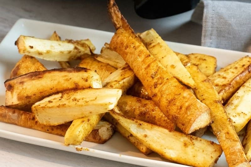 Air fryer parsnip fries on a white plate.