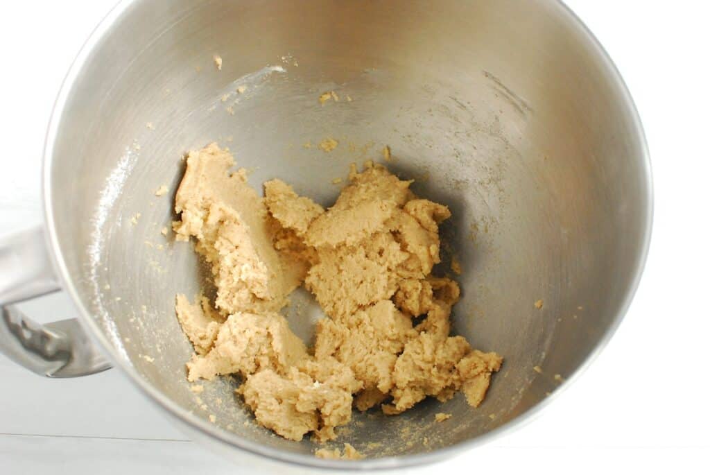 Butter, granulated sugar, and brown sugar mixed together in a bowl.