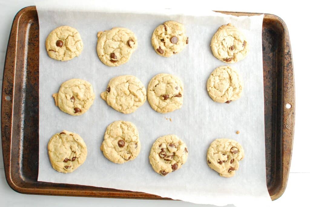 Baked cookies on a parchment-lined baking sheet.