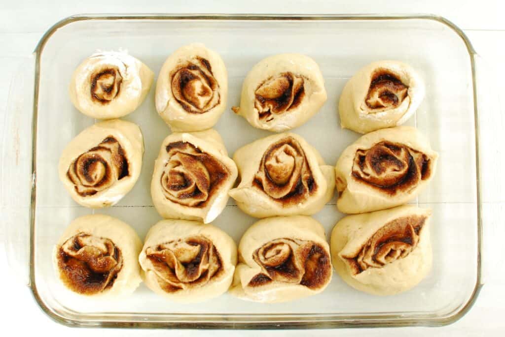 Uncooked cinnamon rolls in a baking dish.