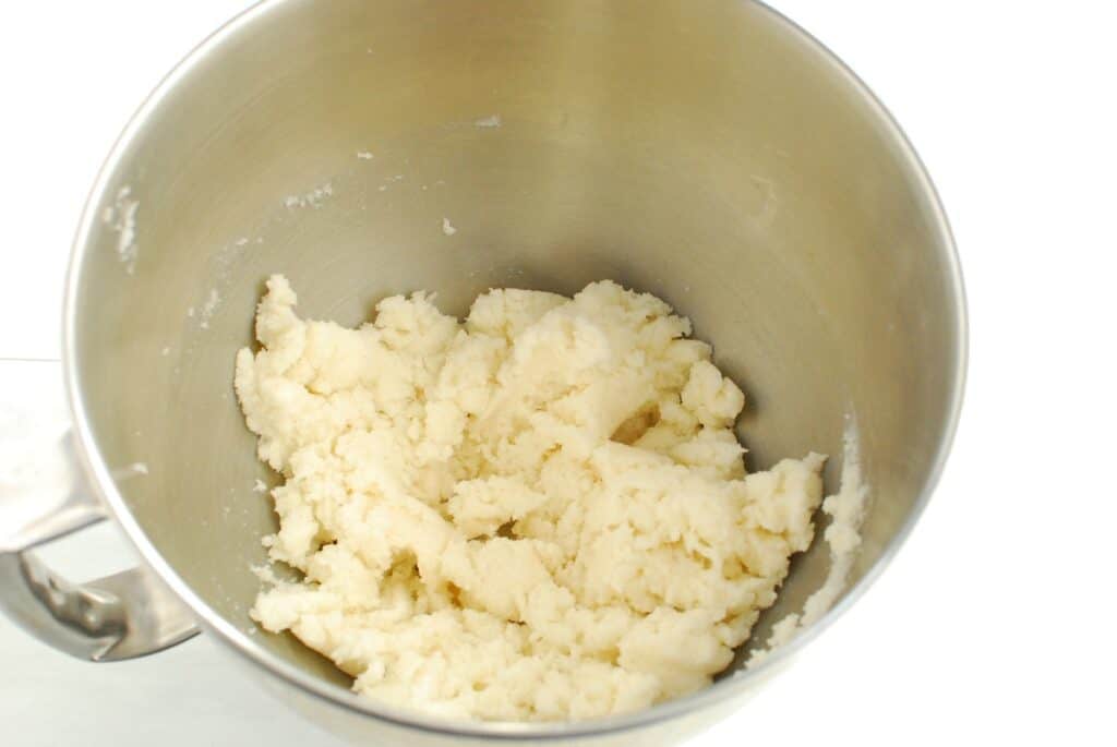 Butter and sugar creamed together in a mixing bowl.