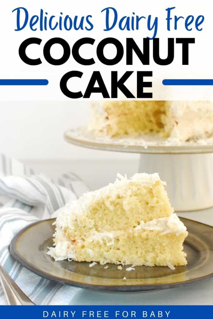 A slice of dairy free coconut cake on a plate next to a napkin and a cake stand.