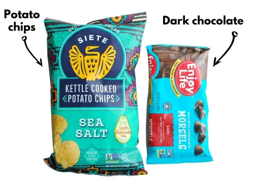 A bag of potato chips and a bag of dark chocolate chips.