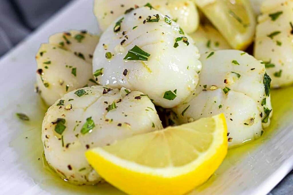 Lemon scallops on a white plate.