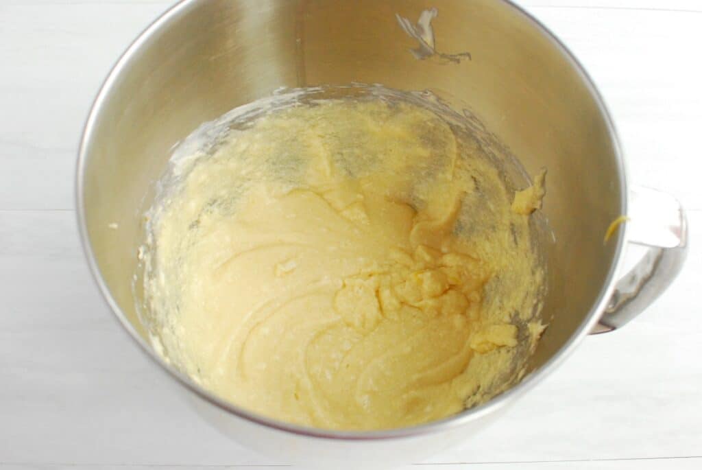 Dairy free butter, sugar, oil, eggs, and vanilla mixed together in a bowl.