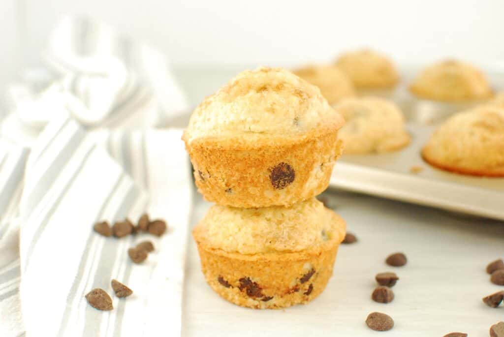 Two dairy free chocolate chip muffins stacked on top of each other.