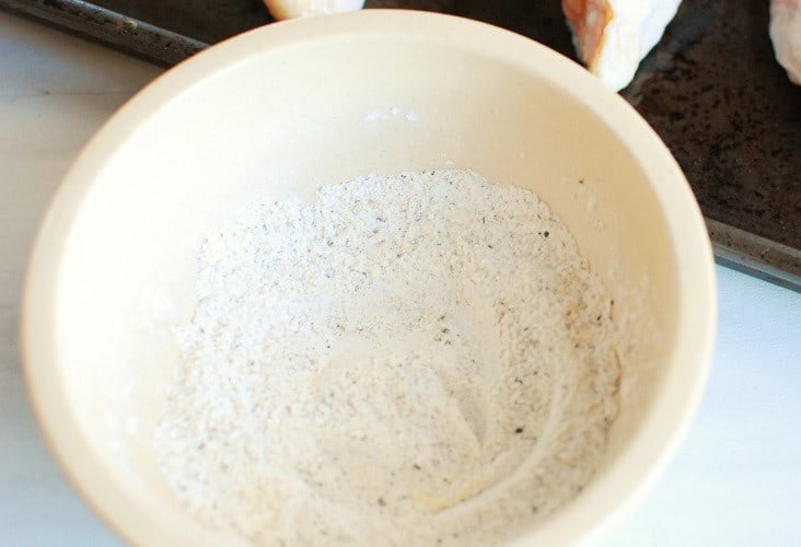 Baking powder, garlic powder, salt and pepper mixed together in a small bowl.