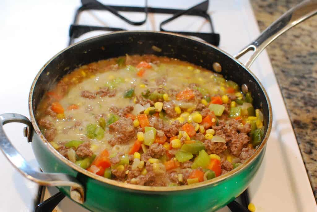 The base of the casserole sautéing in a pan.