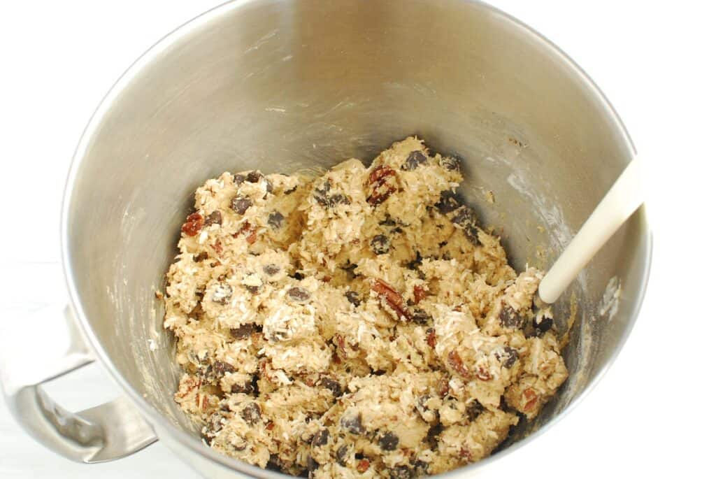 Cookie dough in a silver mixing bowl.