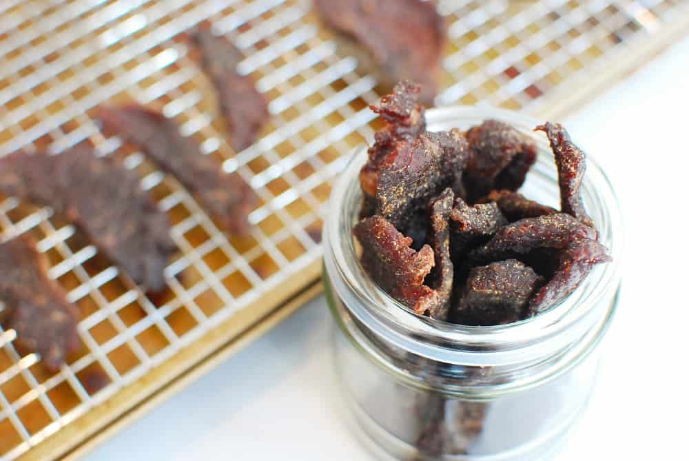 A jar with beef jerky in it.