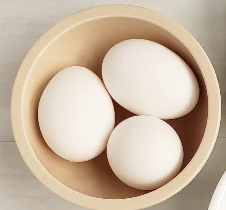 A bowl with three hardboiled eggs.