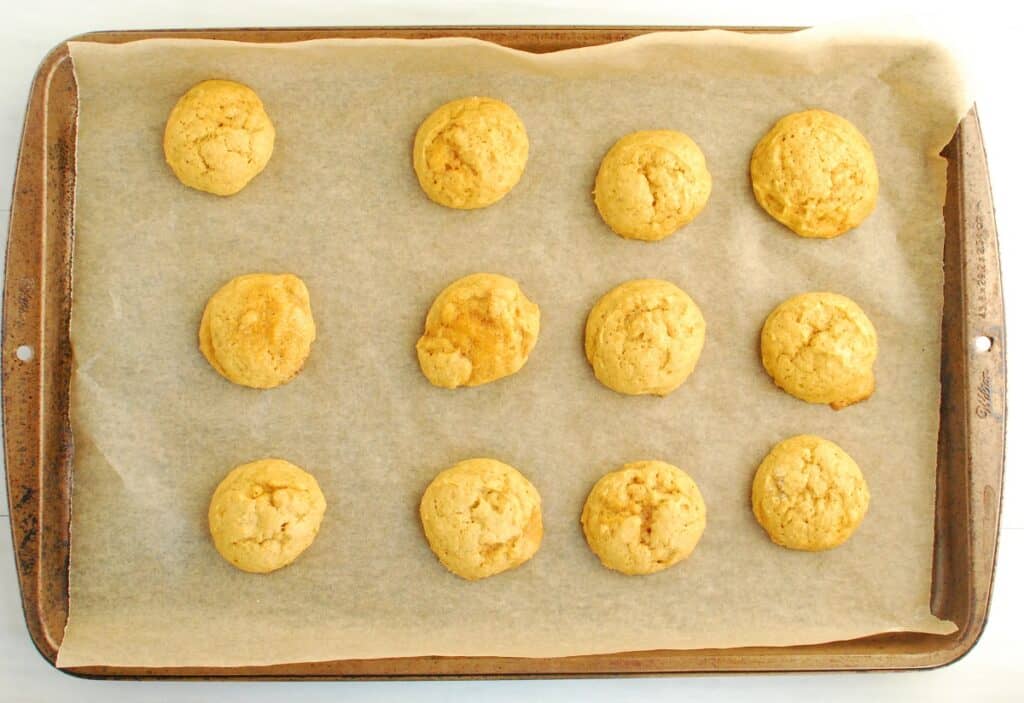 Baked dairy free pumpkin cookies on parchment paper.