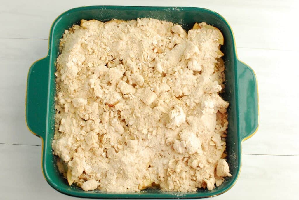 Uncooked apple crisp in a baking dish.