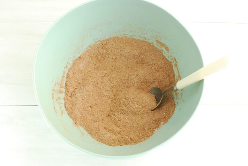 Sugar, cocoa powder, flour, and salt mixed together in a bowl.