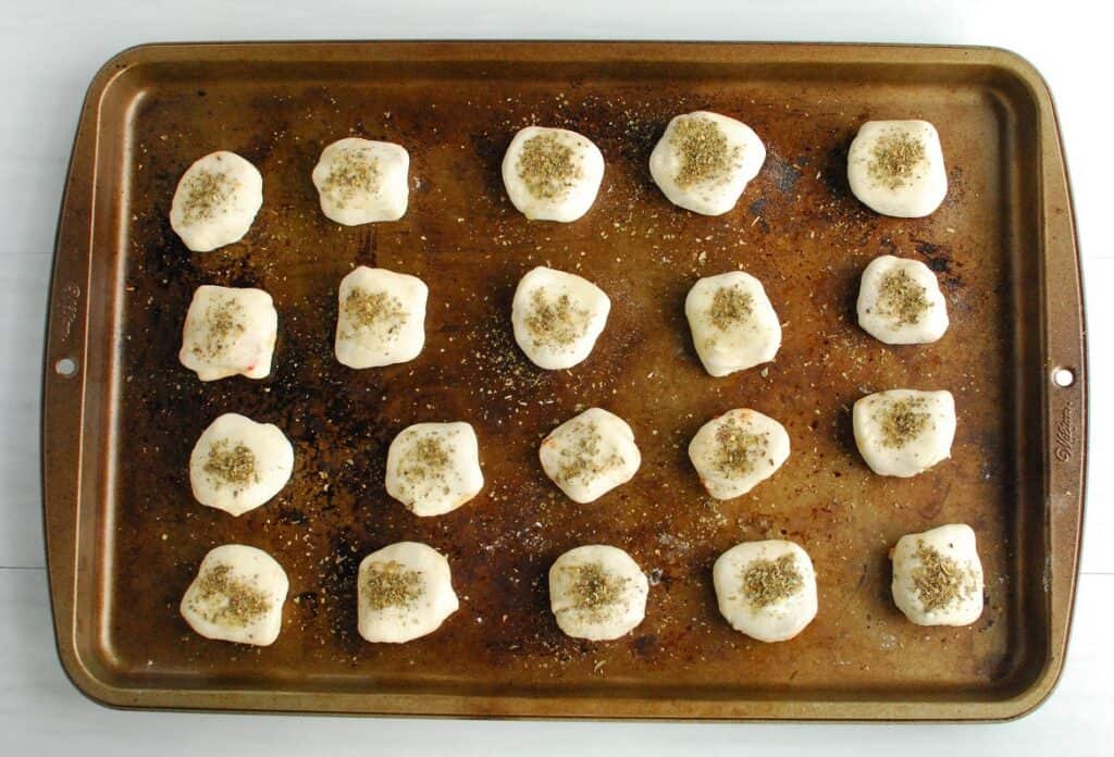 A pan of unbaked pizza bombs.