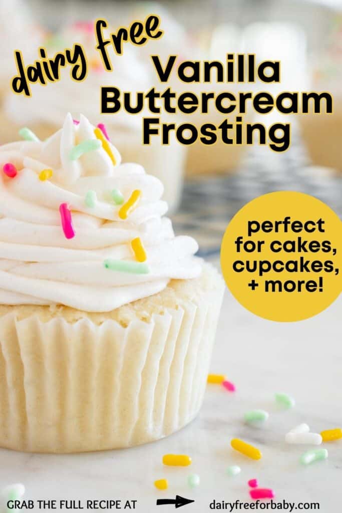 A vanilla cupcake topped with dairy free buttercream frosting, with sprinkles on top and on the counter.