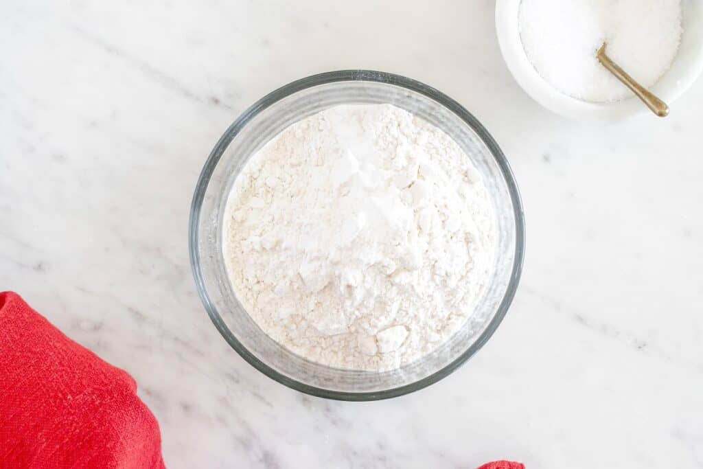 Flour, baking soda, and salt mixed together in a bowl.