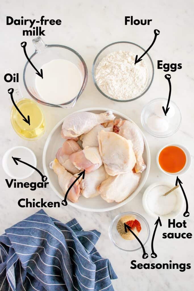 Chicken, seasonings, hot sauce, vinegar, oil, dairy free milk, flour, and eggs.