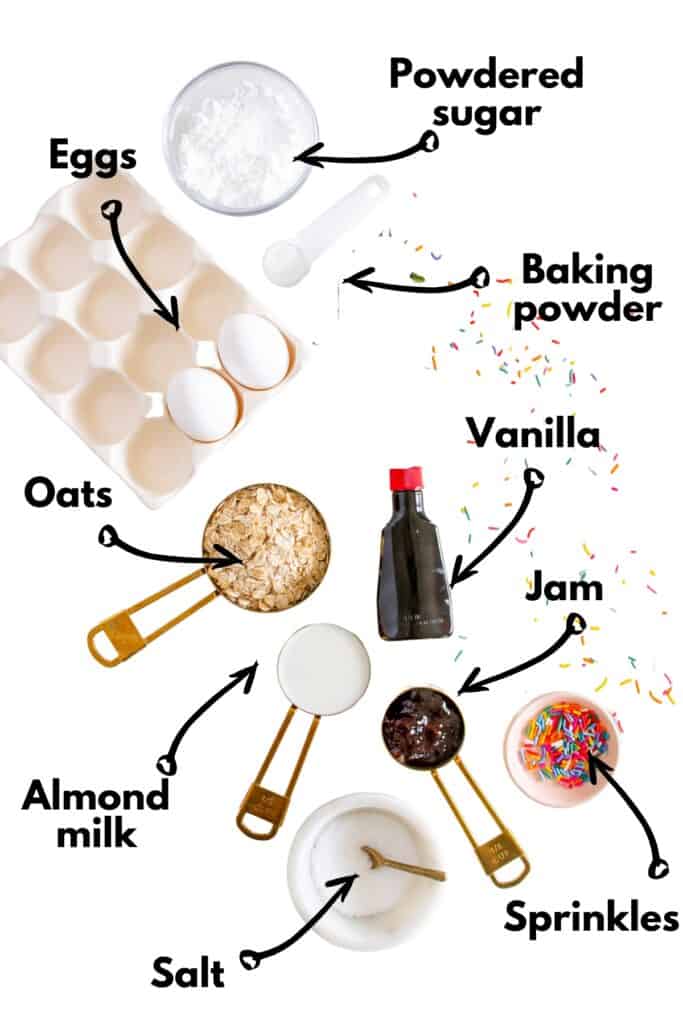 Eggs, oats, almond milk, baking powder, salt, vanilla, jam, sprinkles, and powdered sugar.
