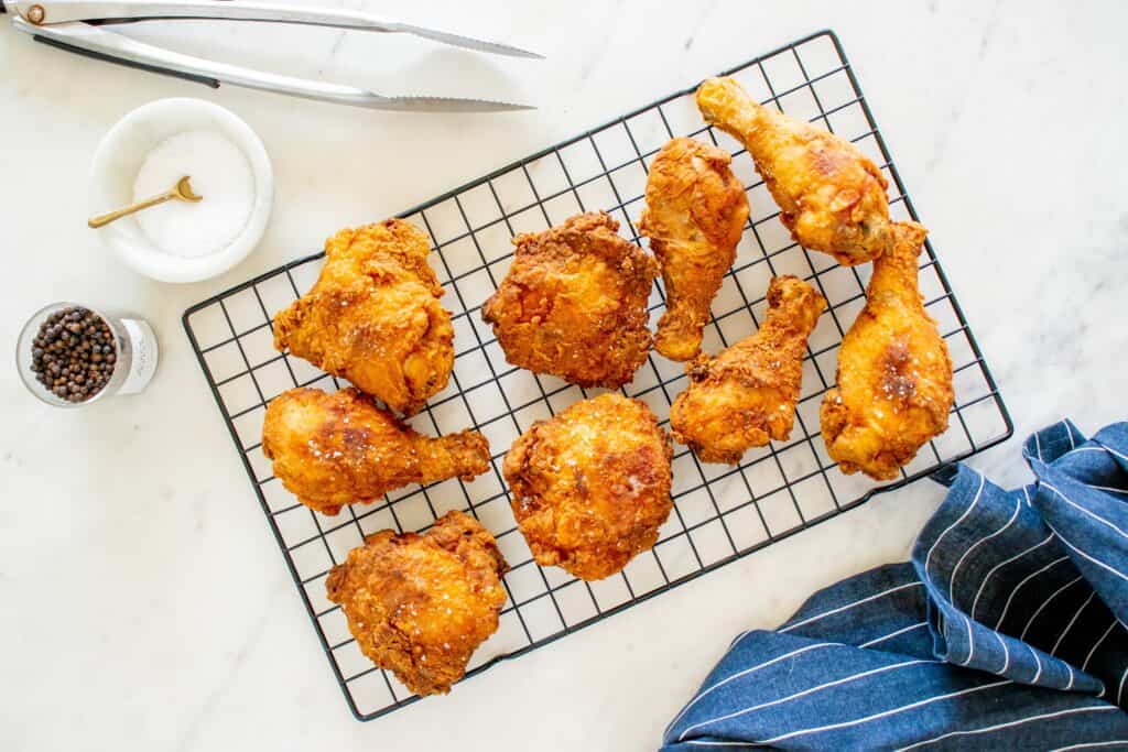 Freshly cooked dairy free fried chicken on a cooling rack.