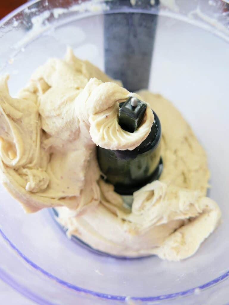 Creamy dairy free banana ice cream in a food processor bowl.