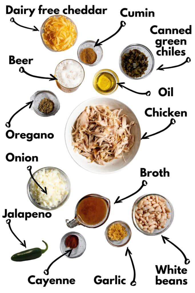 All of the ingredients to make the chili recipe spread out on a white backdrop.