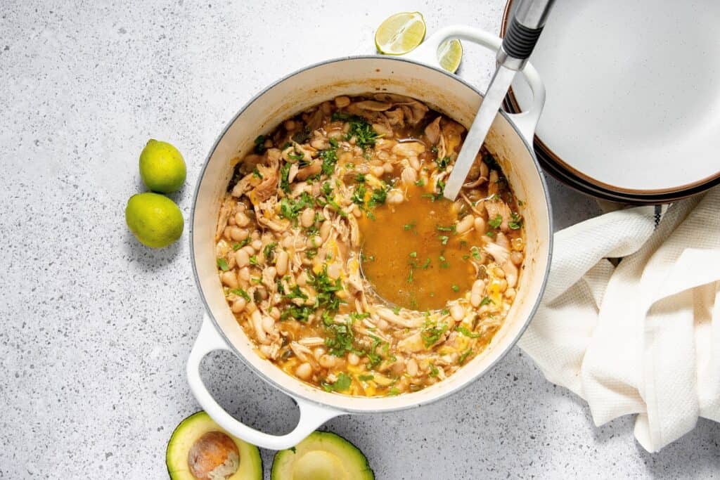 A finished pot of dairy free white chicken chili topped with some cilantro.