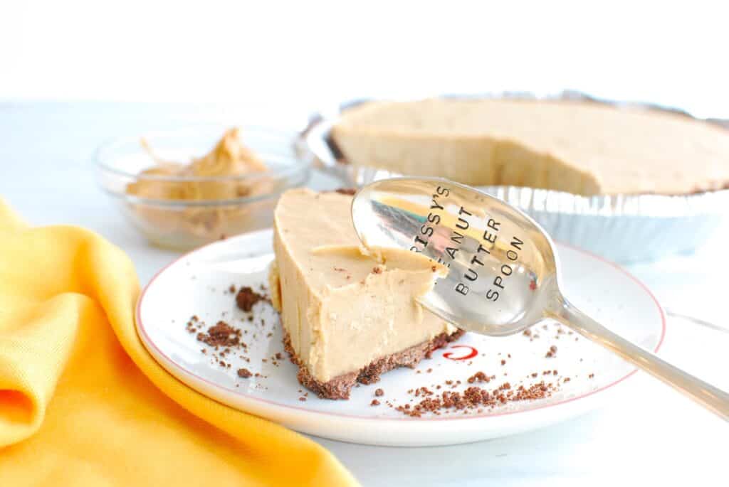 A slice of peanut butter banana pie with a spoon stuck into it.