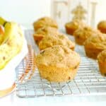 An almond butter banana muffin on a cooling rack.