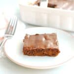 A dairy free lunch lady brownie on a plate with a fork next to it.