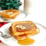 Two slices of dairy free eggnog French toast topped with syrup.