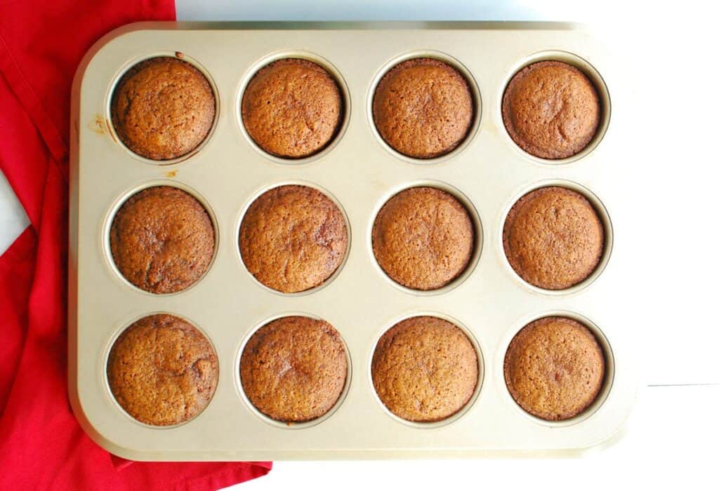 Just-baked dairy free gingerbread cupcakes still in the baking tin.
