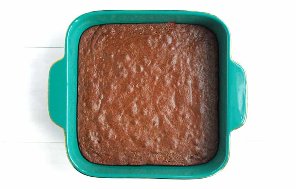 A fresh baked batch of gingerbread brownies in an 8x8 dish.