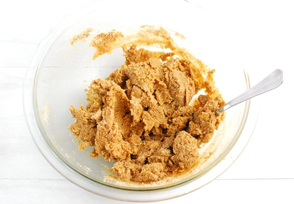 Cookie dough in a glass mixing bowl.