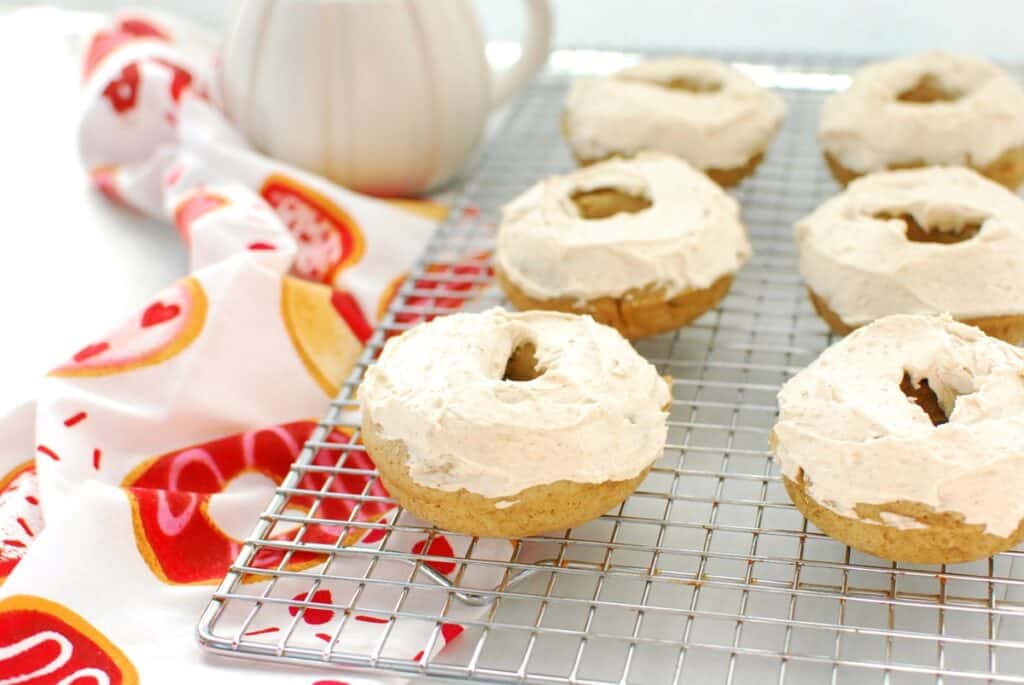 Several dairy free chai donuts on a cooling rack.