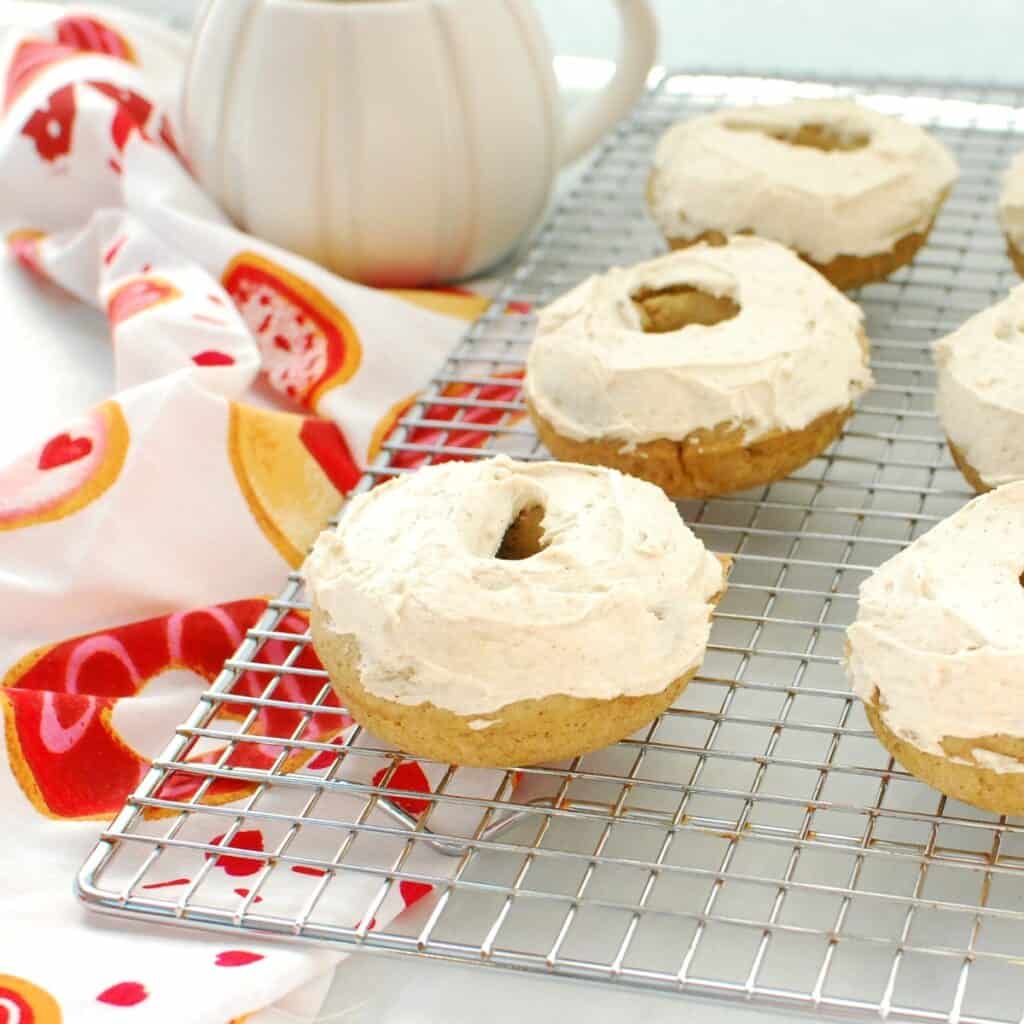 A dairy free chai donut on a cooling rack next to a napkin.