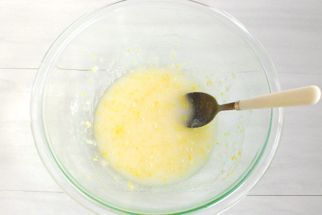 Sugar, lemon juice, and olive oil mixed together in a bowl.