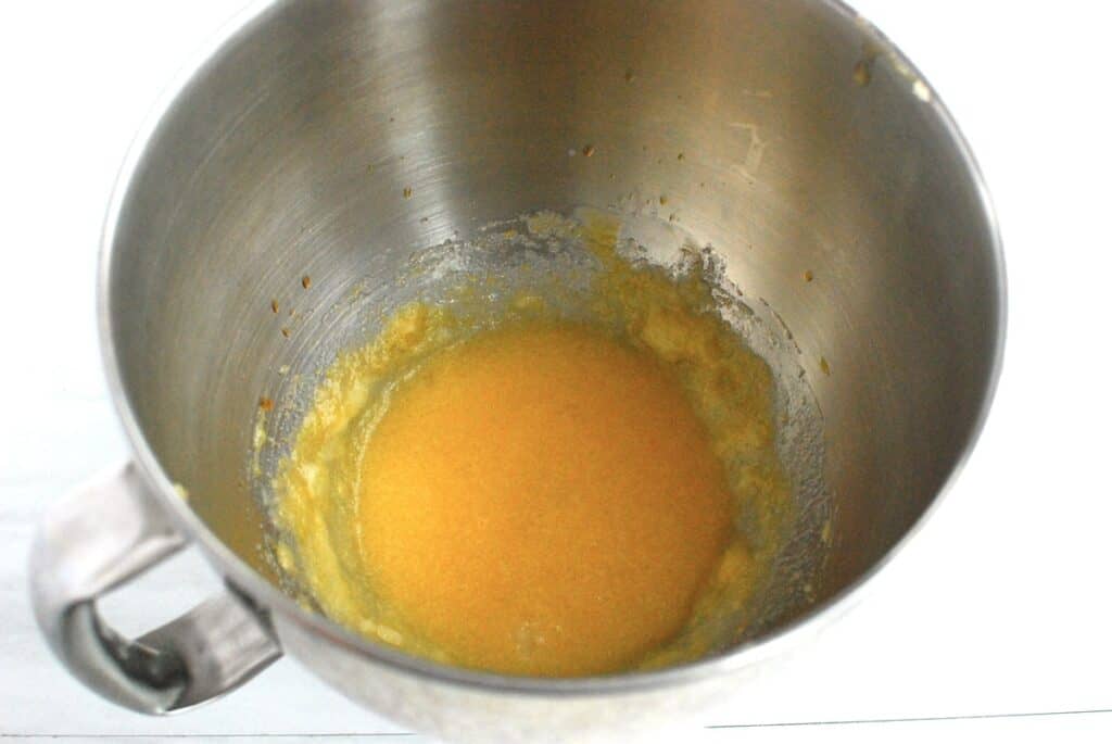 Sugar, oil, almond milk, egg, and vanilla mixed together in a bowl.