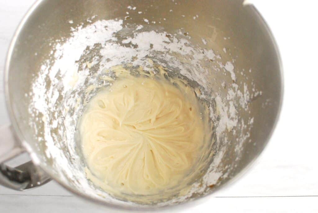 Light and fluffy dairy-free cream cheese fosting in a mixing bowl.