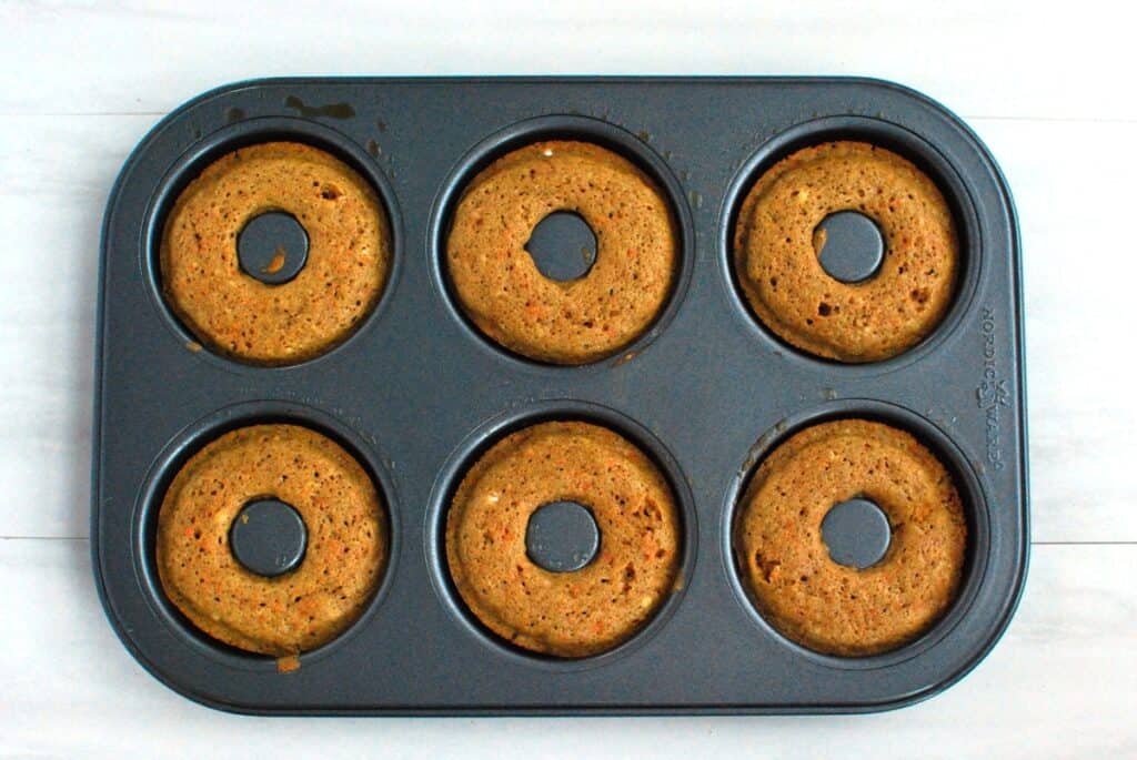 Baked donuts in a donut tin.