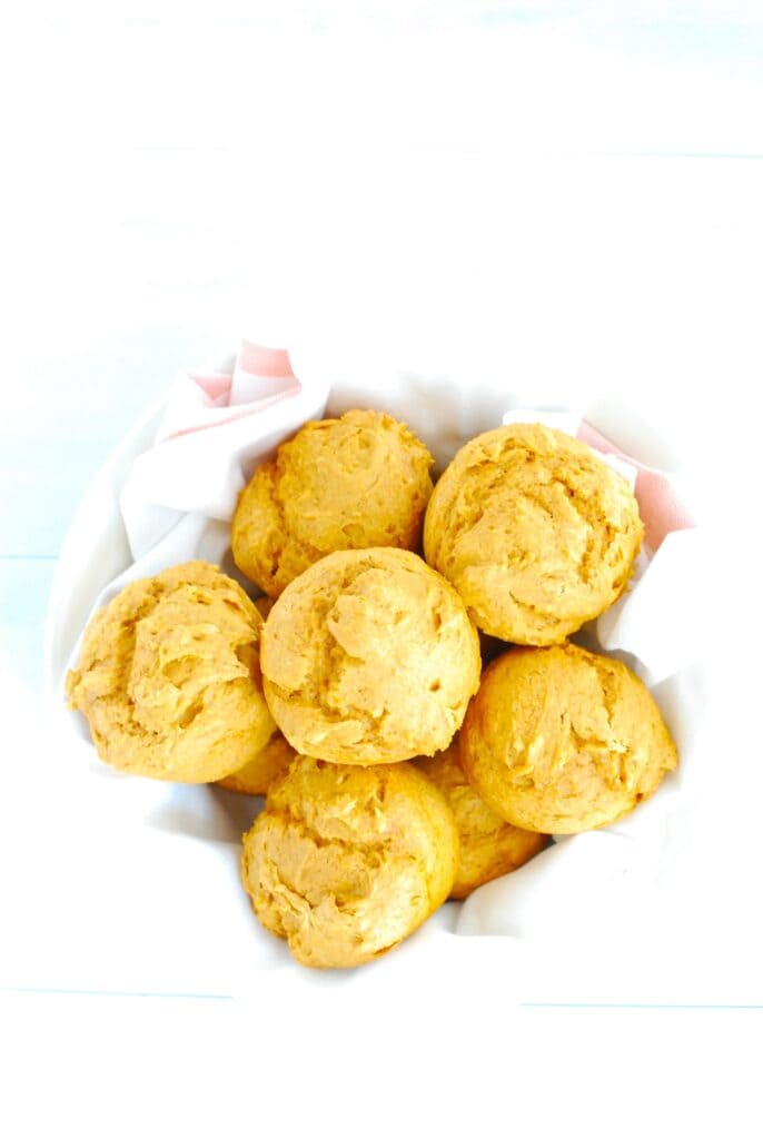 A basket filled with three ingredient pumpkin muffins.