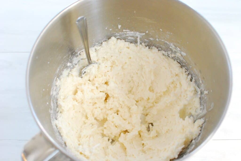 Coconut frosting in a silver mixing bowl.