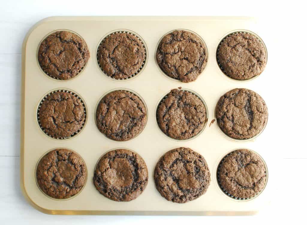 Just-baked cupcakes that are still in the cupcake tin.