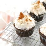 A dairy free almond joy cupcake on a cooling rack.
