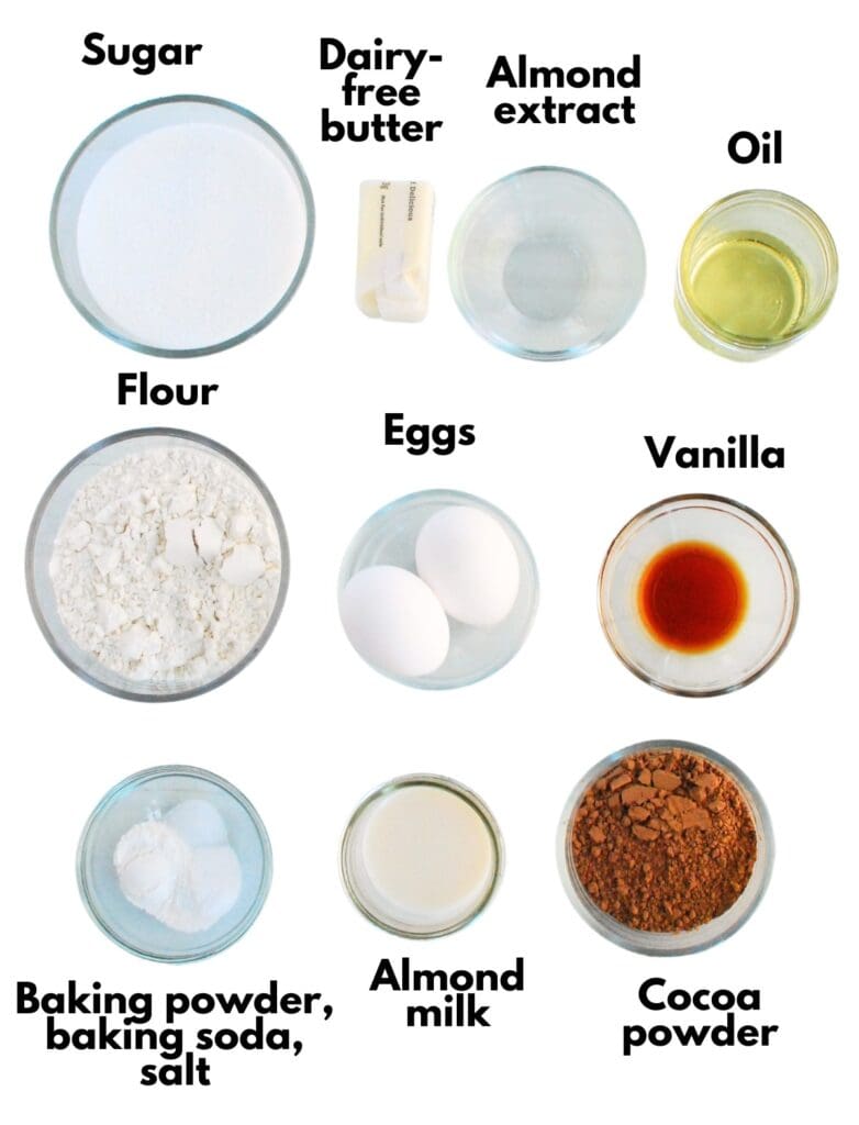 Sugar, dairy free butter, almond extract, oil, flour, eggs, vanilla, baking powder, baking soda, salt, almond milk, and cocoa powder.