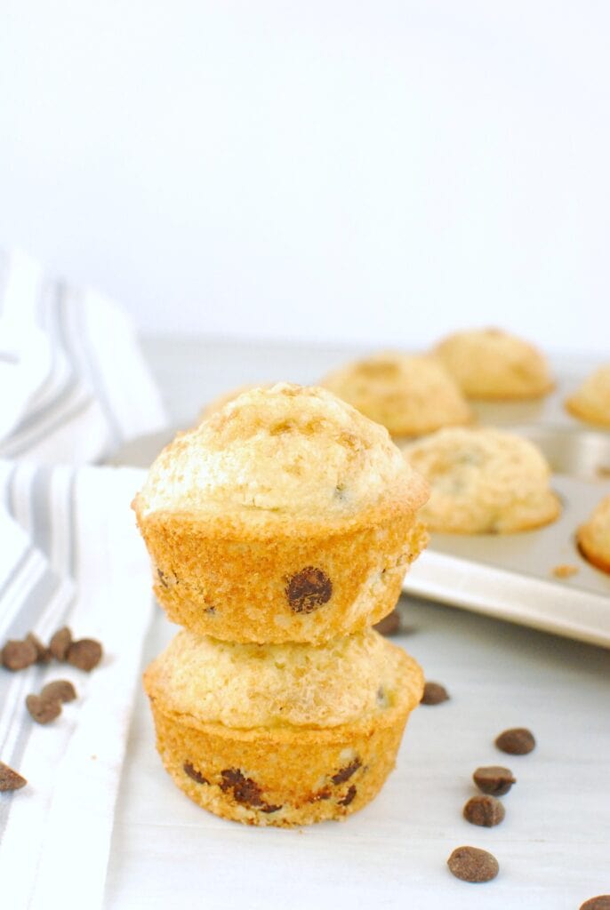 Two dairy free chocolate chip muffins stacked on top of each other.