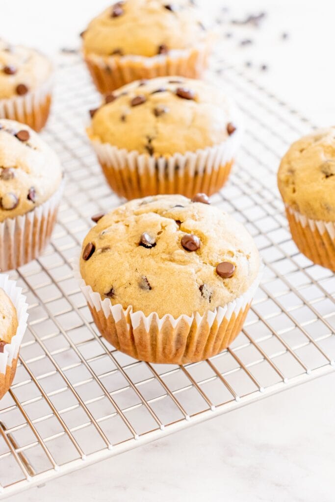 Olive oil banana muffins on a cooling rack.