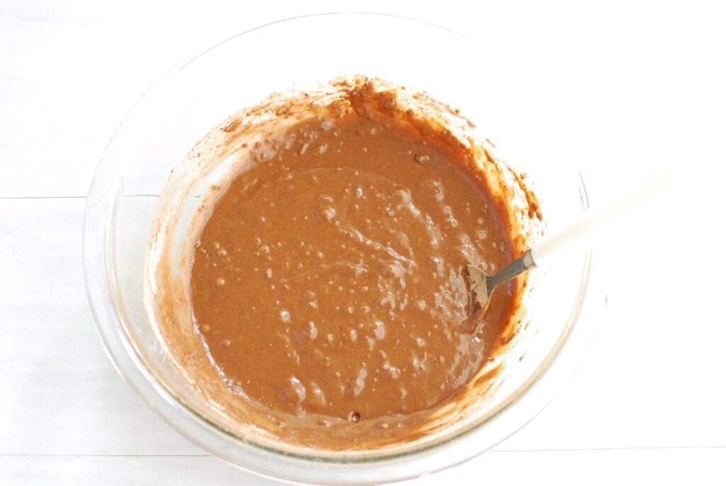 Donut batter in a glass mixing bowl.